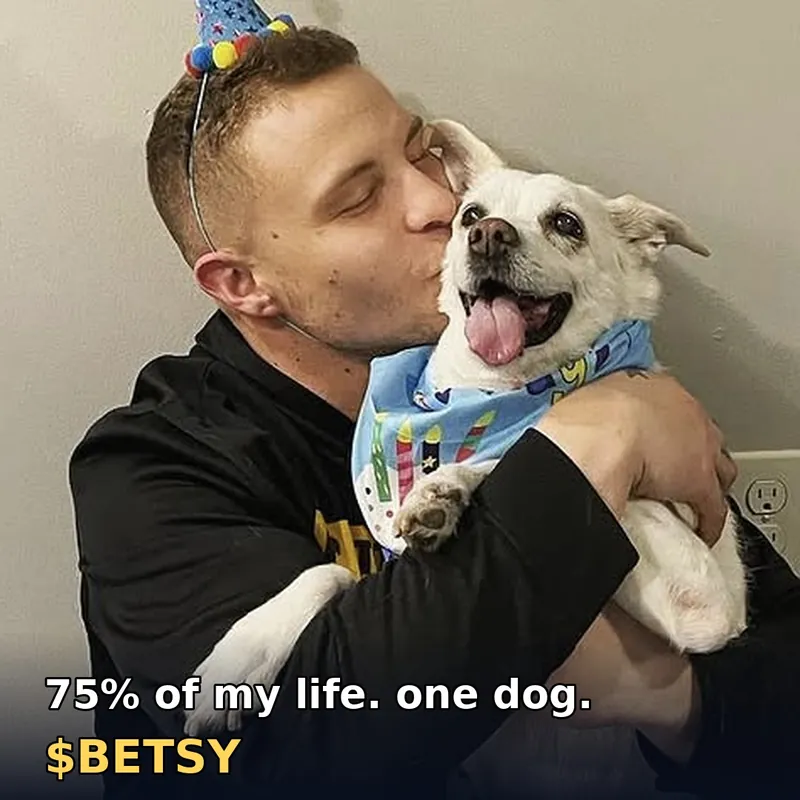 Zech kissing Betsy in her birthday bandana: 75% of my life. one dog.